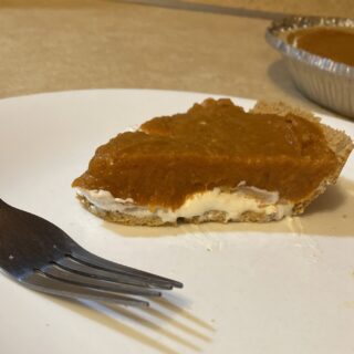 Slice of Double Layer Pumpkin Pie on a Plate