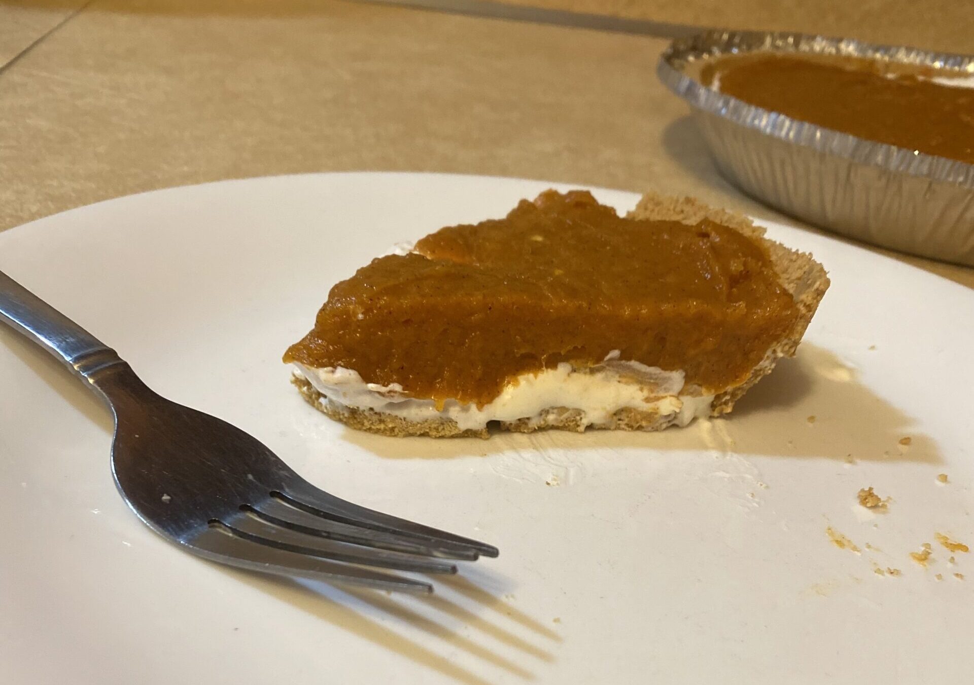 Slice of Double Layer Pumpkin Pie on a Plate